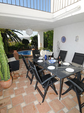 The outdoor dining area overlooks the pool at Bay View, Costa del Sol