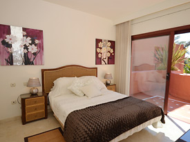 The bright and airy double bedroom opens onto the front terrace at Menara Beach, Estepona 