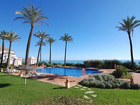 Tropical gardens surround the pool at La Perla Beach
